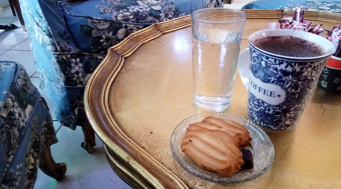 Some coffee and cookies on a golden table at Kekkos cafe